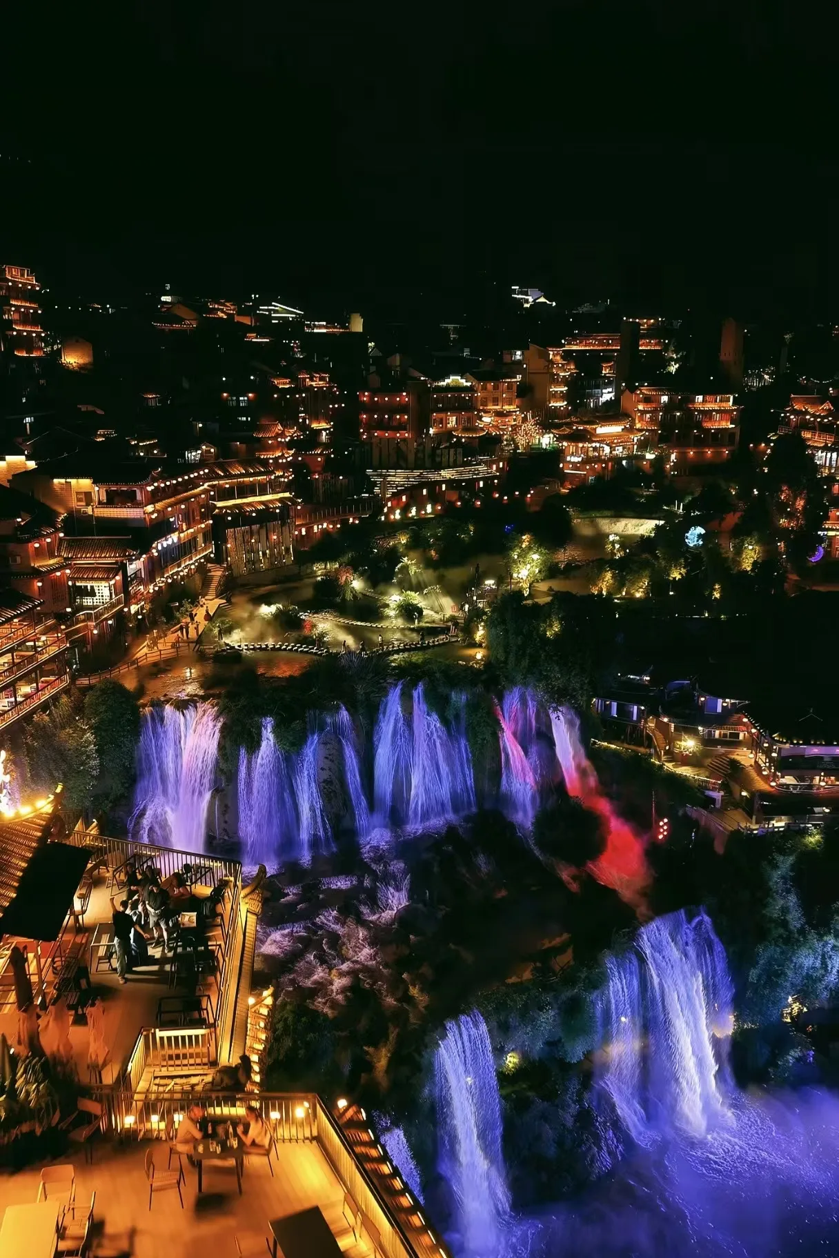 A Waterfall Town Illuminated at Night