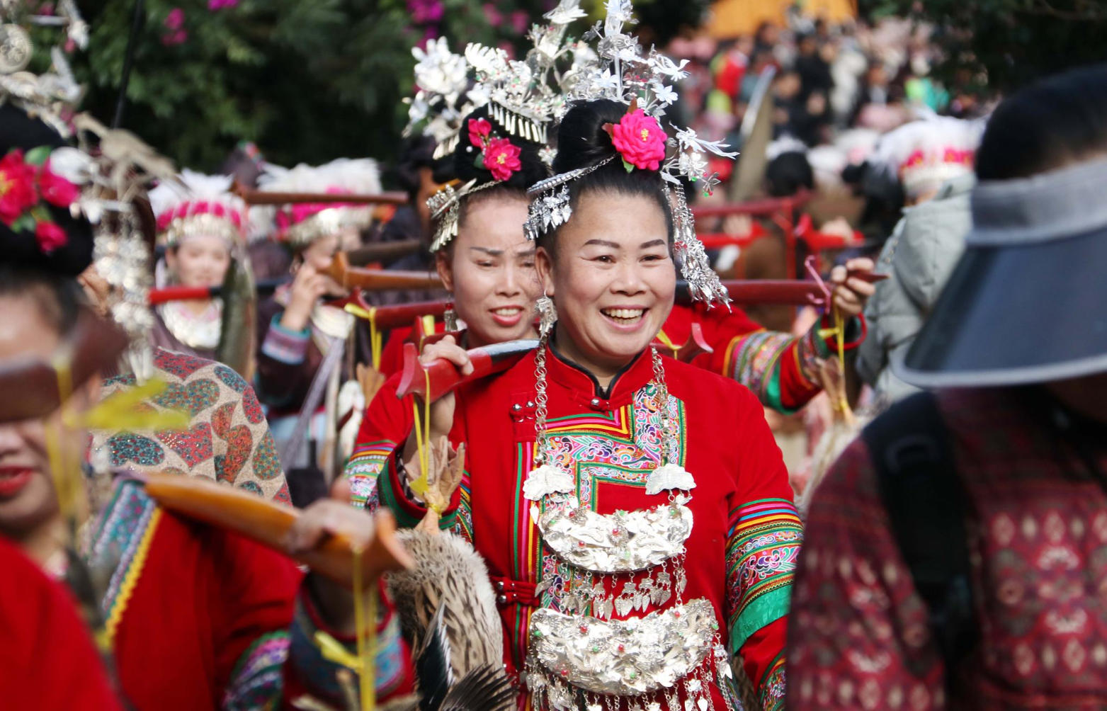 People in colorful traditional minority costumes celebrating a local festival in a Guizhou village